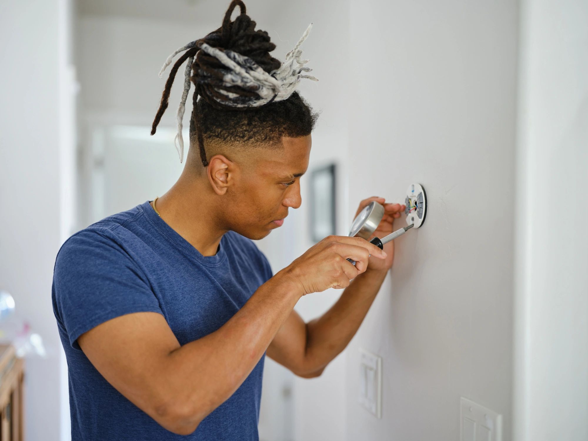 Technician installing smart home equipment in a residence